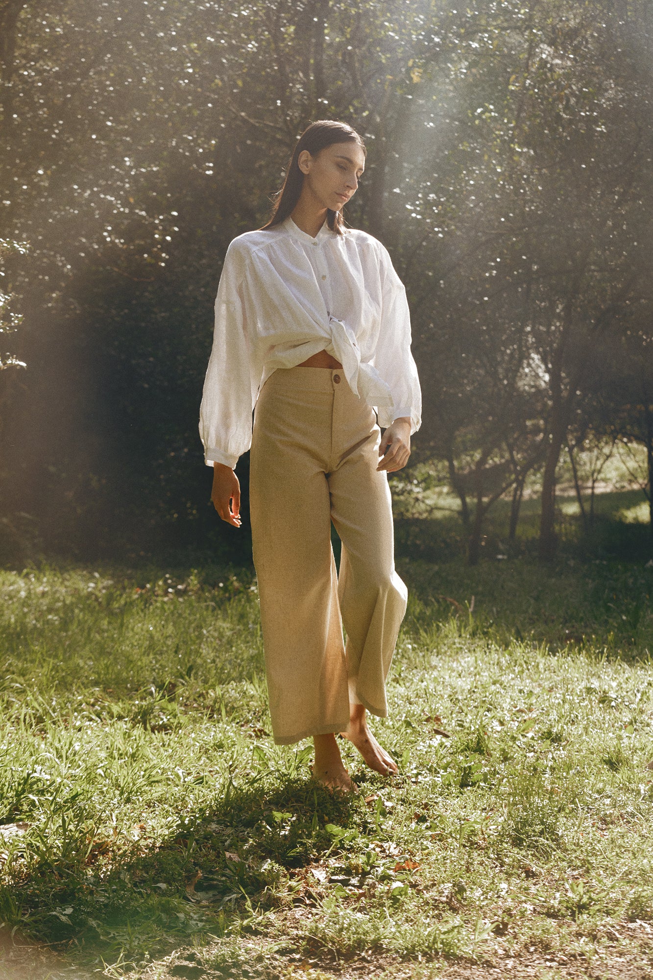 Model wearing Museā Barley Trousers in the forest