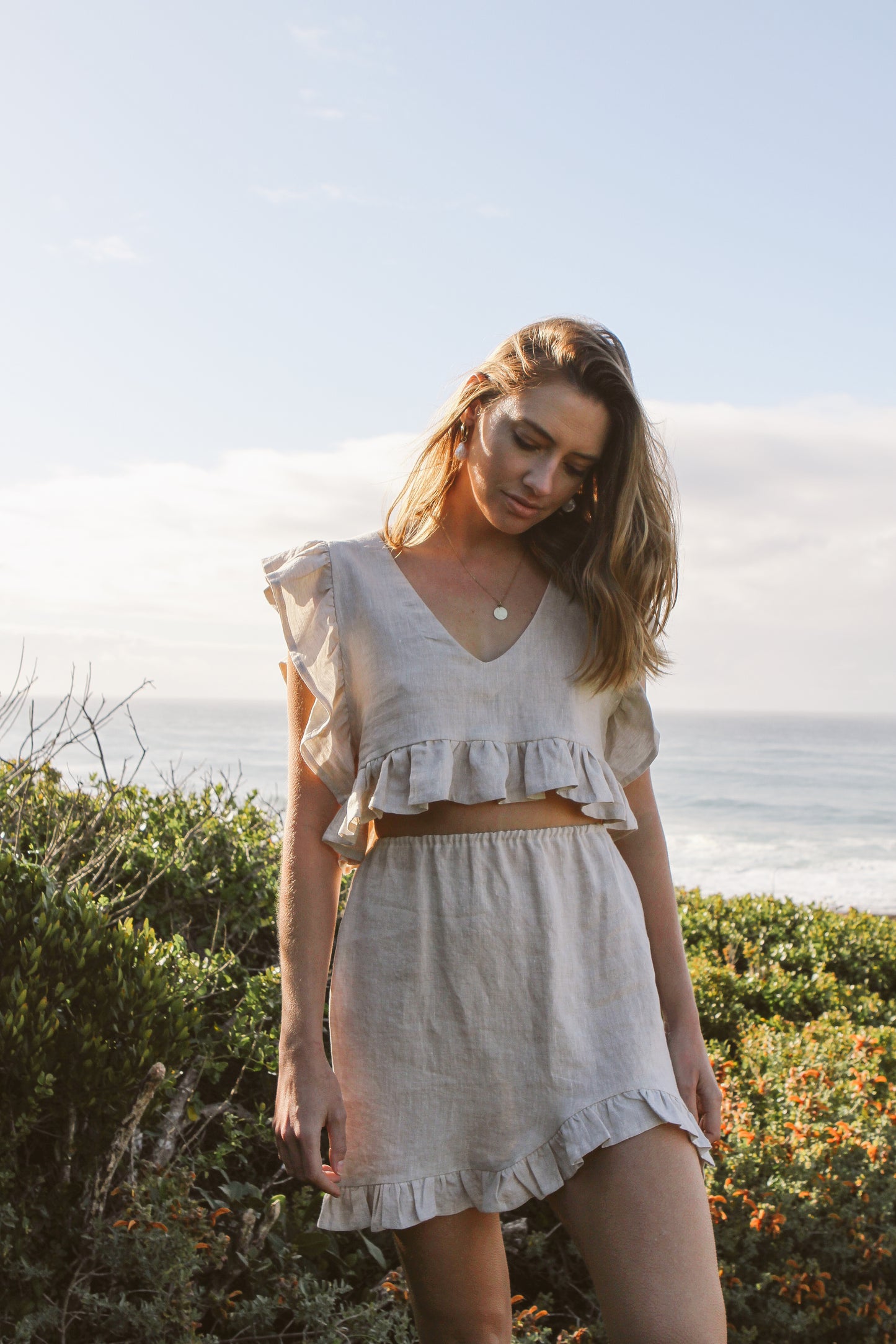 Model wearing frilly top and skirt
