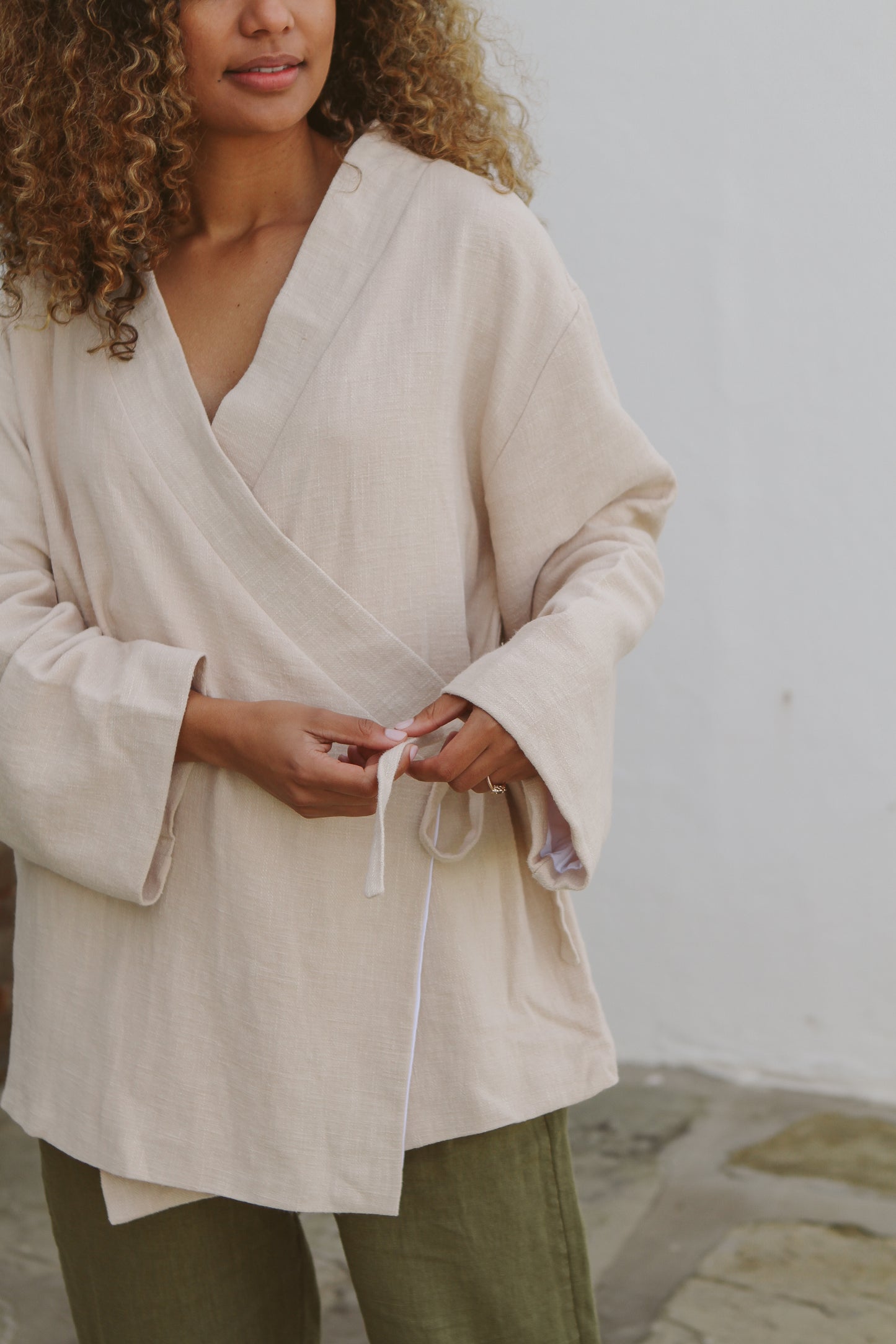 Model tying jacket closed