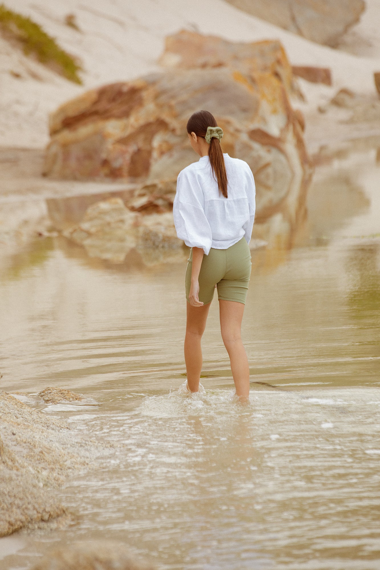 Model wearing sage bodysuit and Bartolomeu linen shirt