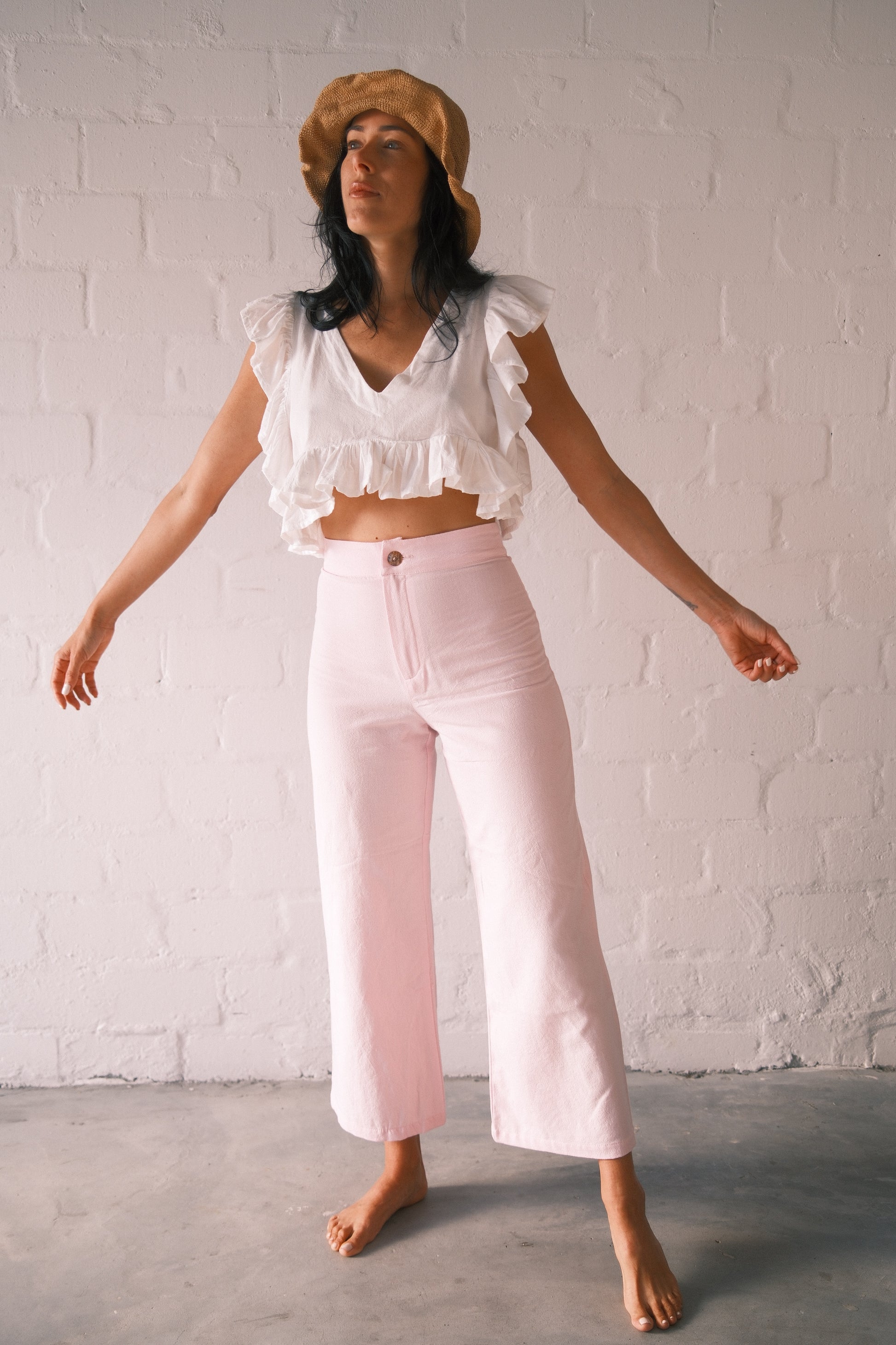 Model wearing soft pink barley trousers.