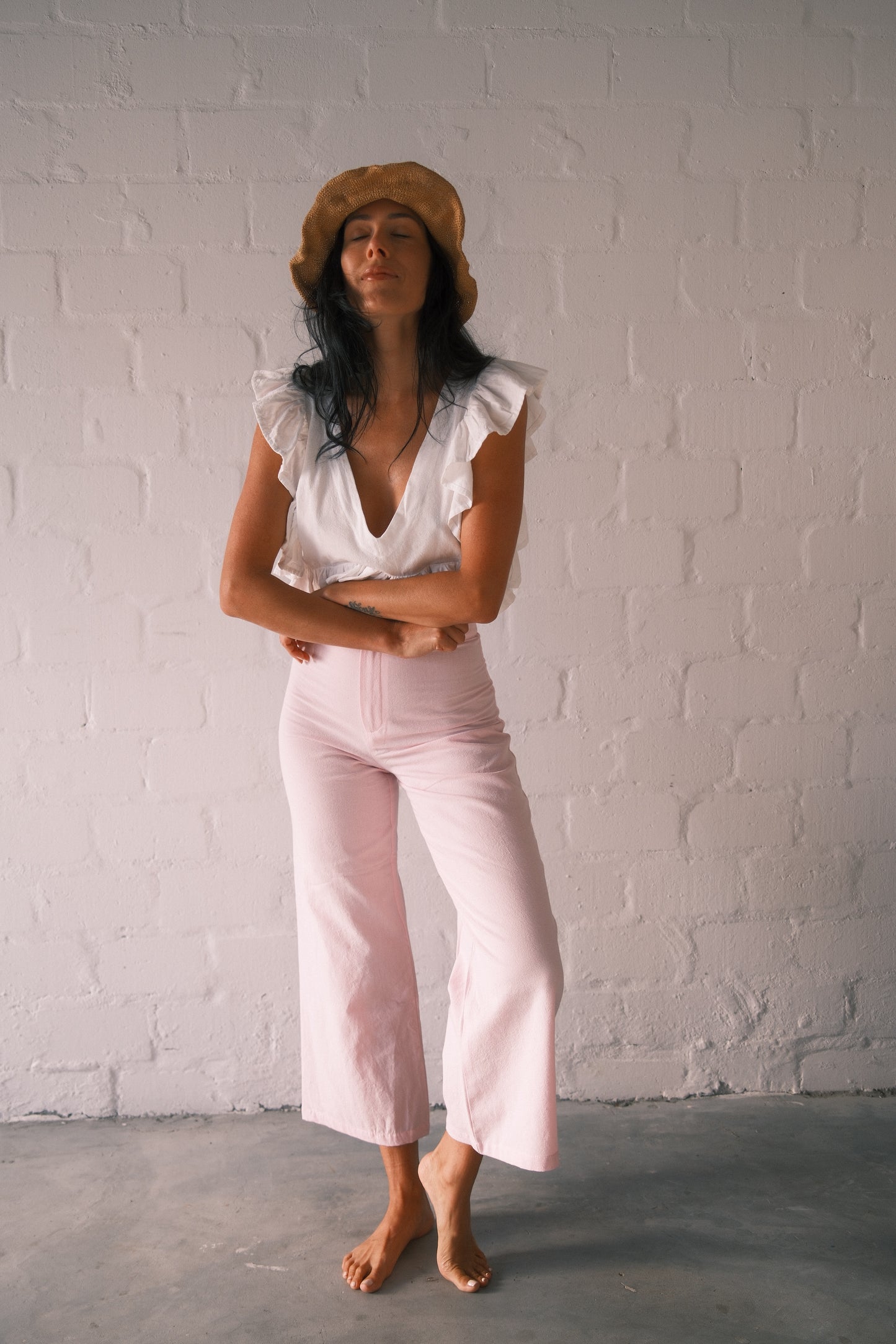 Model wearing soft pink barley trousers.