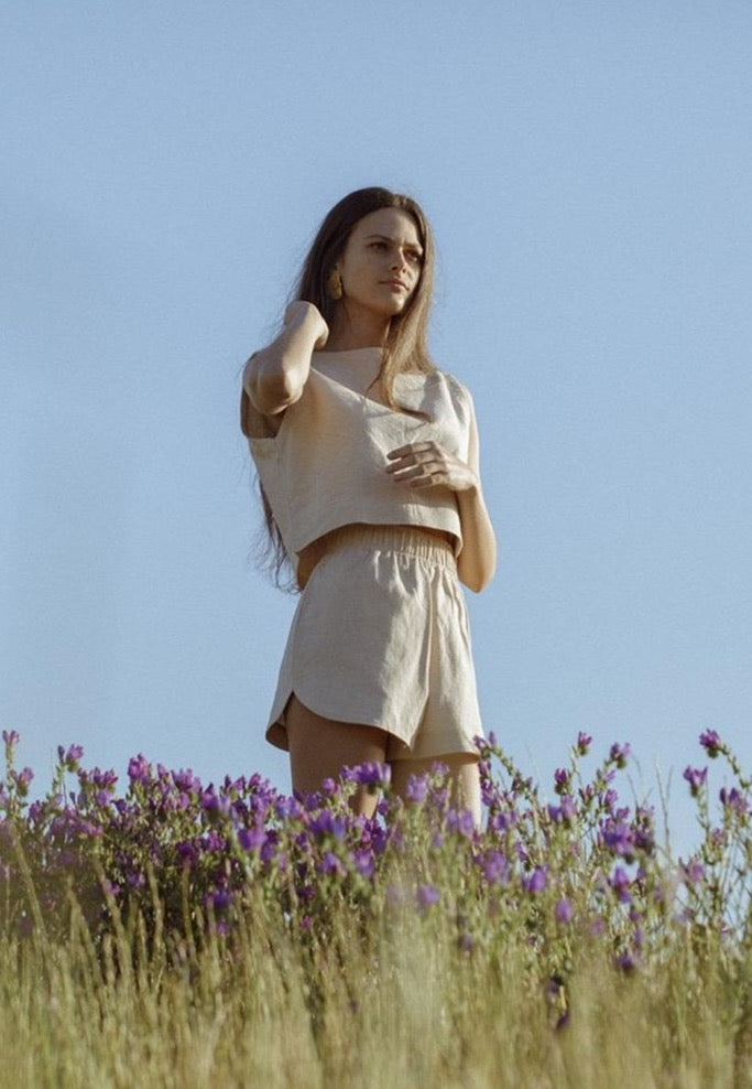 Model in a field wearing the Beth shorts