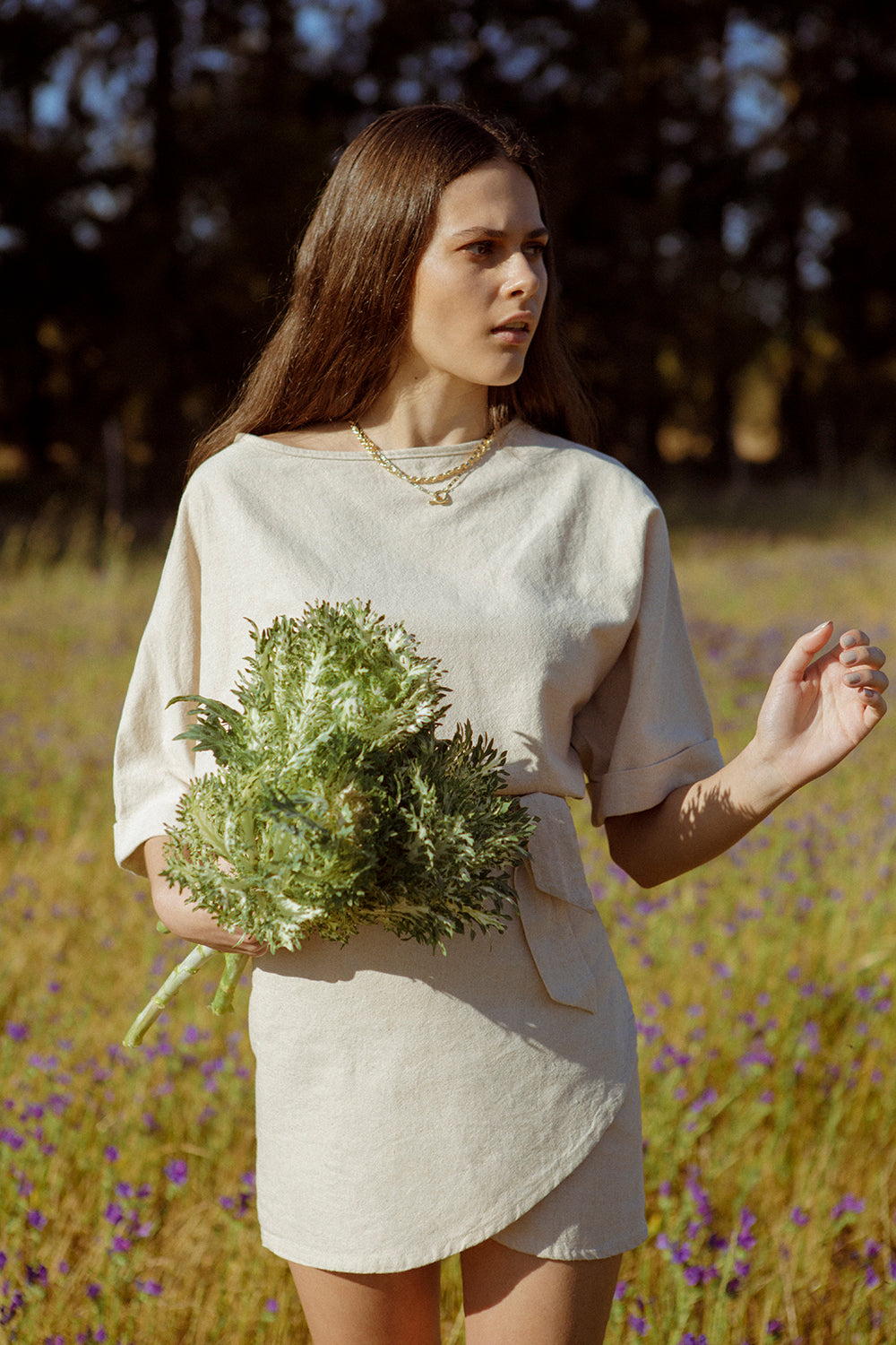 Model wearing the Nori Top while in a field