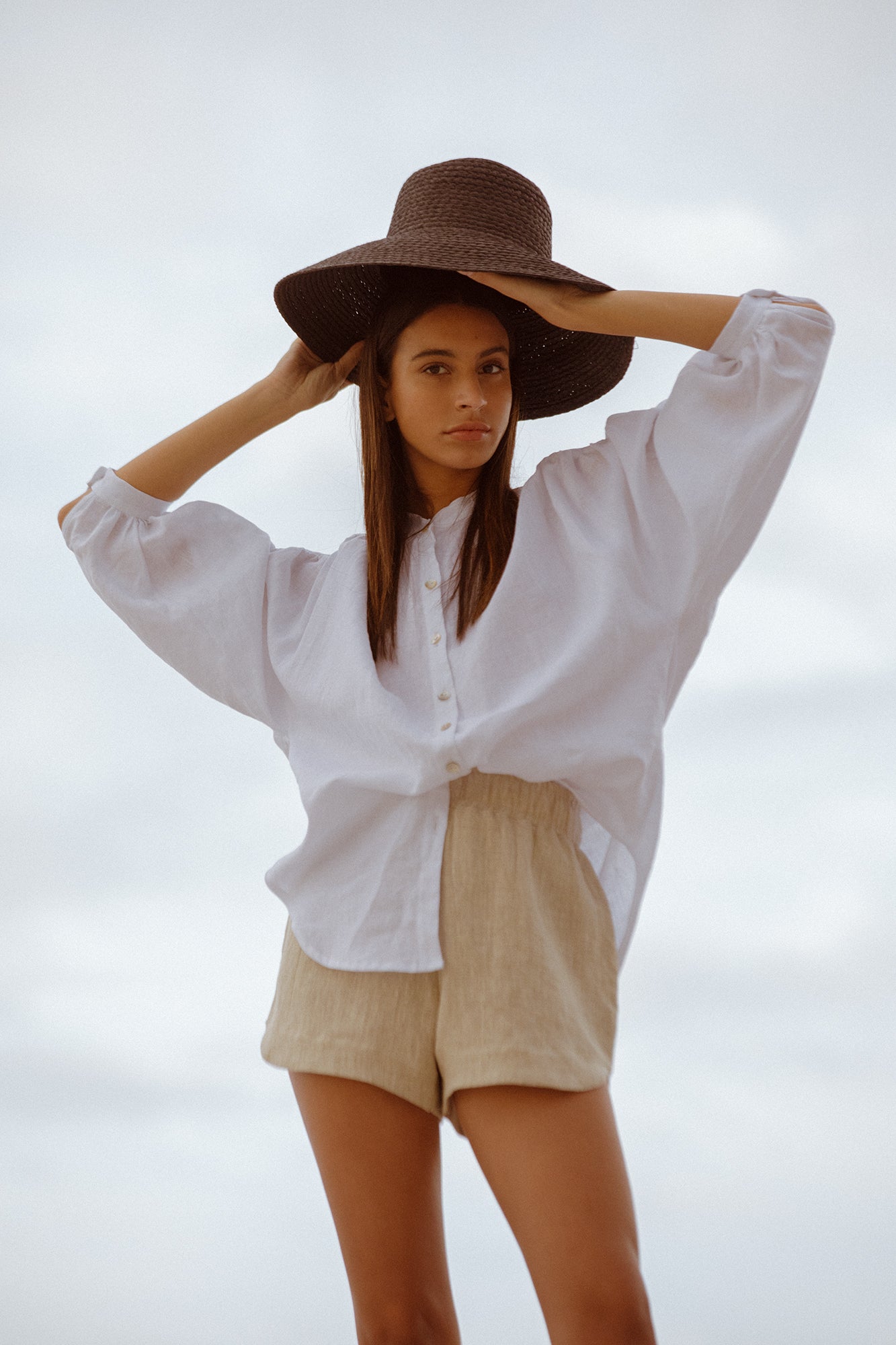 model wearing white linen Bartolomeu shirt and beth shorts