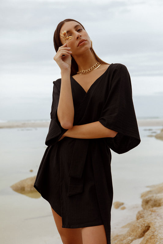 model wearing short Alya dress in black cotton